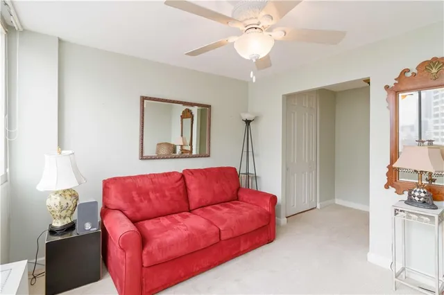 a living room with furniture a couch and a chandelier