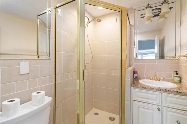 a bathroom with a shower sink and mirror