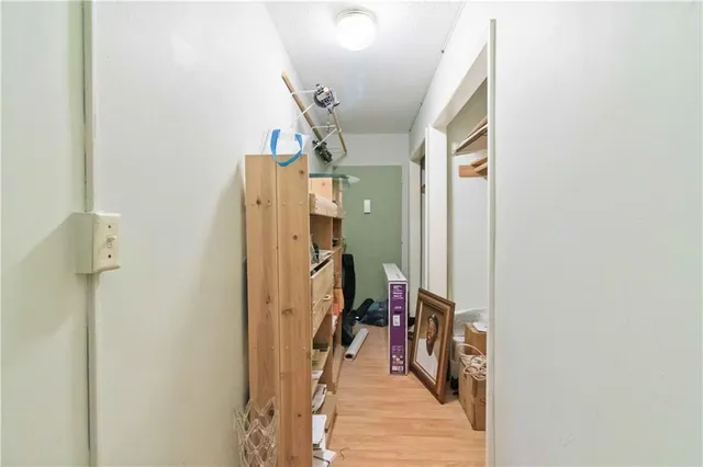 a view of a hallway with wooden floor and stairs