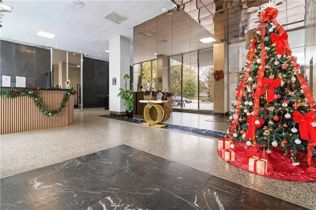 a lobby with furniture and floor to ceiling window