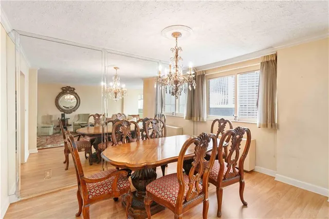 a view of a dining room with furniture and chandelier