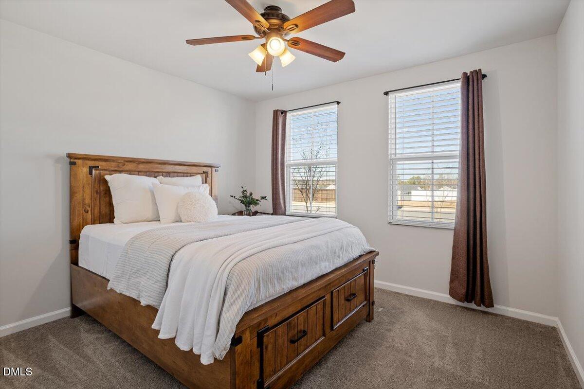 278 Hunting Wood Drive Angier, NC 27501 - Photo 11 of 36 a spacious bedroom with a bed and a chandelier