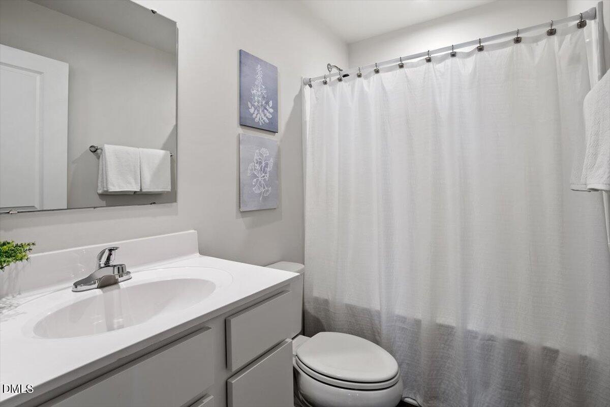 278 Hunting Wood Drive Angier, NC 27501 - Photo 13 of 36 a bathroom with a sink a toilet and shower