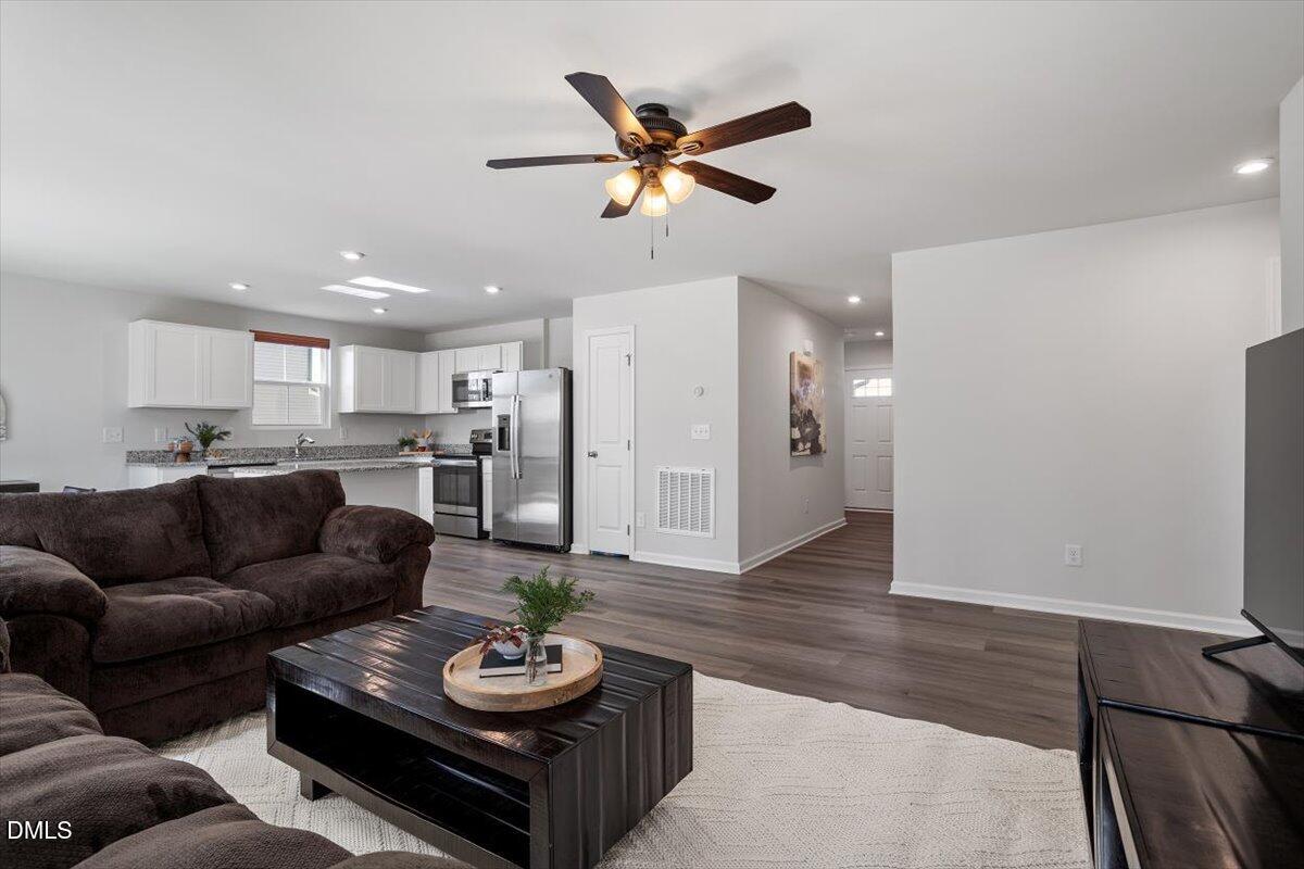 278 Hunting Wood Drive Angier, NC 27501 - Photo 18 of 36 a living room with furniture and kitchen view