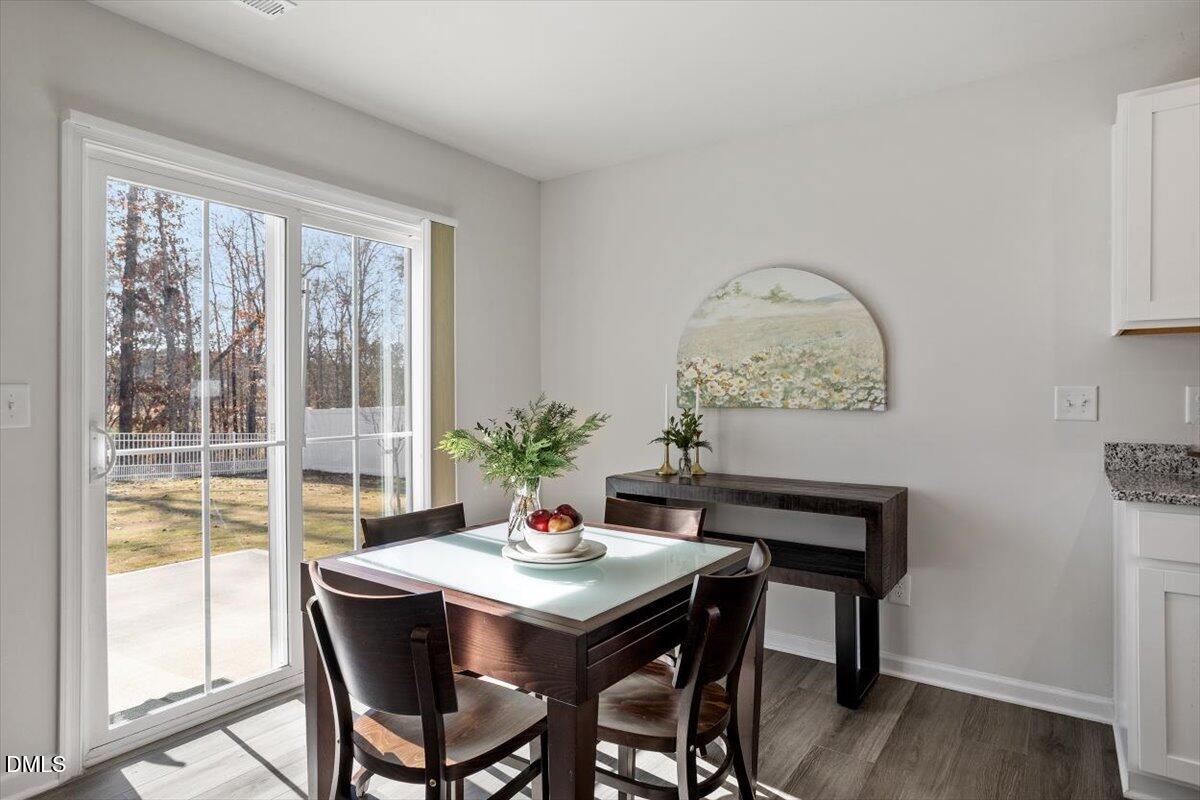 278 Hunting Wood Drive Angier, NC 27501 - Photo 19 of 36 a view of a dining room with furniture window and wooden floor