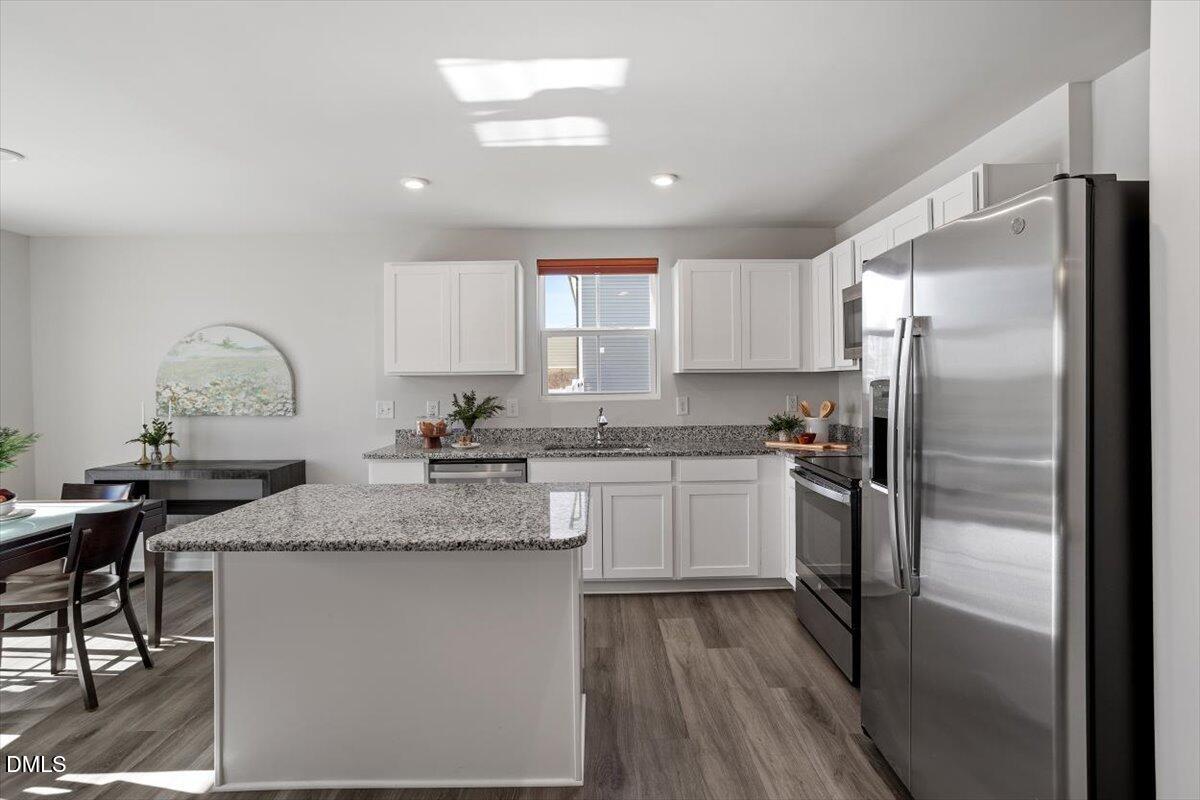 278 Hunting Wood Drive Angier, NC 27501 - Photo 22 of 36 a kitchen with stainless steel appliances granite countertop a refrigerator sink and stove