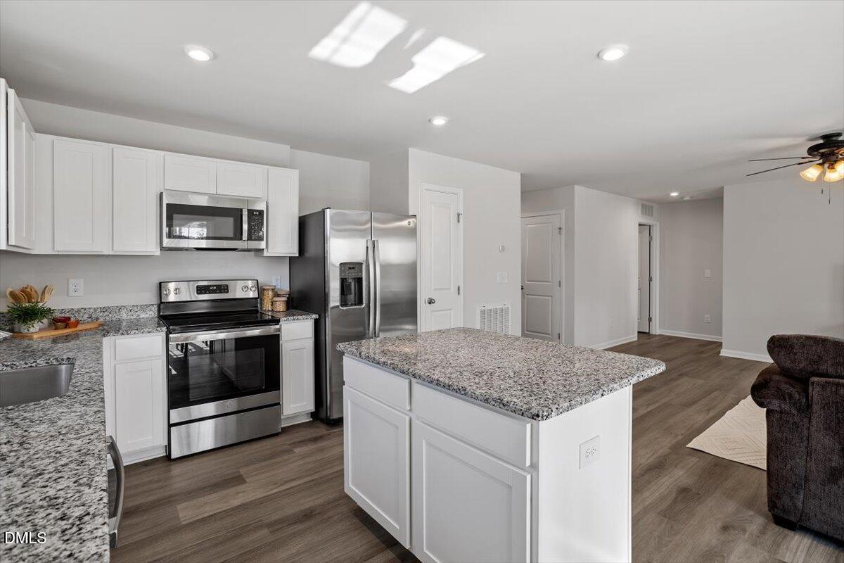 278 Hunting Wood Drive Angier, NC 27501 - Photo 24 of 36 a kitchen with a stove a sink and a refrigerator
