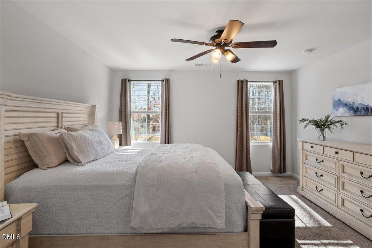 278 Hunting Wood Drive Angier, NC 27501 - Photo 31 of 36 a bedroom with a large bed and a chandelier