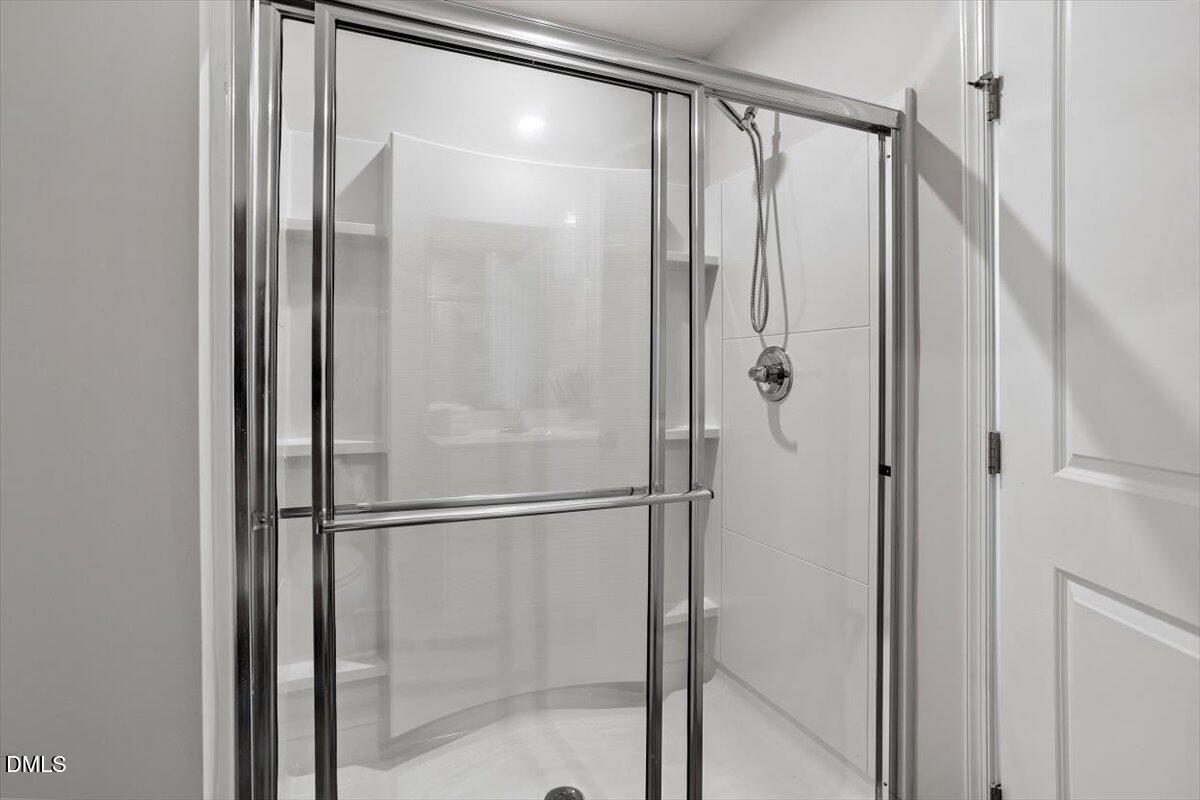 278 Hunting Wood Drive Angier, NC 27501 - Photo 33 of 36 a bathroom with a glass shower door