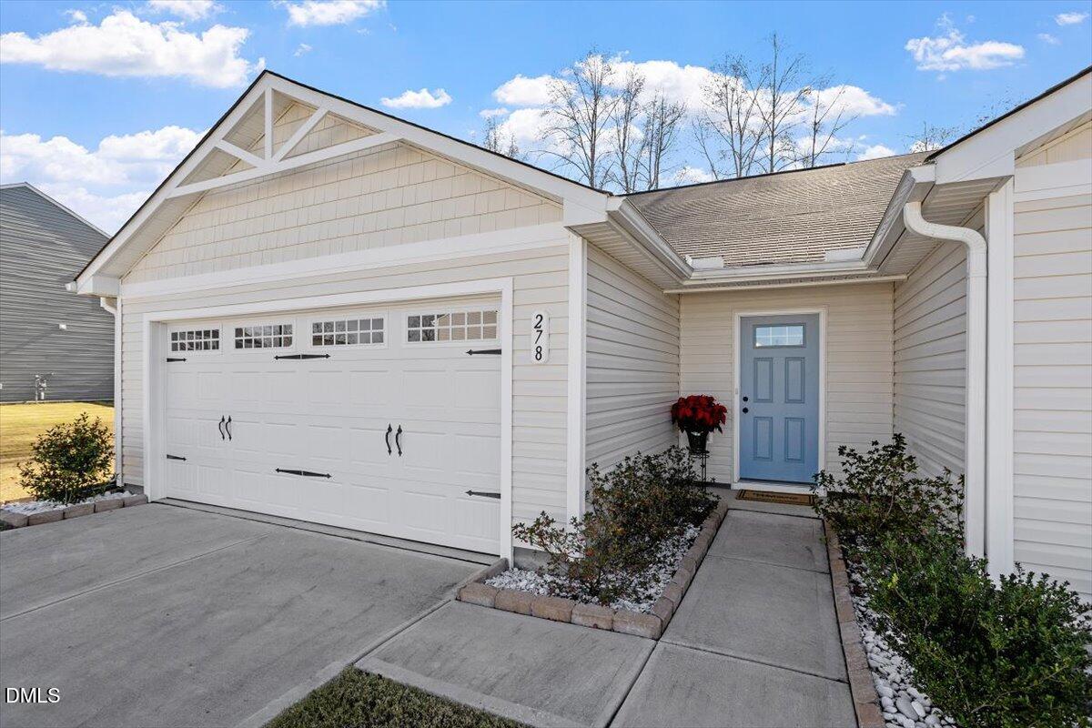 278 Hunting Wood Drive Angier, NC 27501 - Photo 8 of 36 a front view of a house with garden