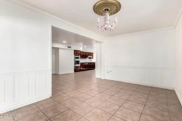 a view of empty room with kitchen