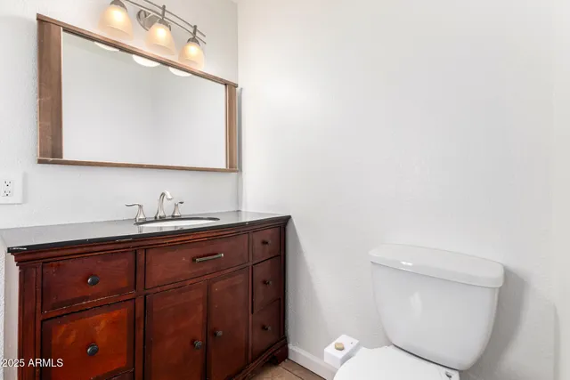 a bathroom with a toilet sink and mirror