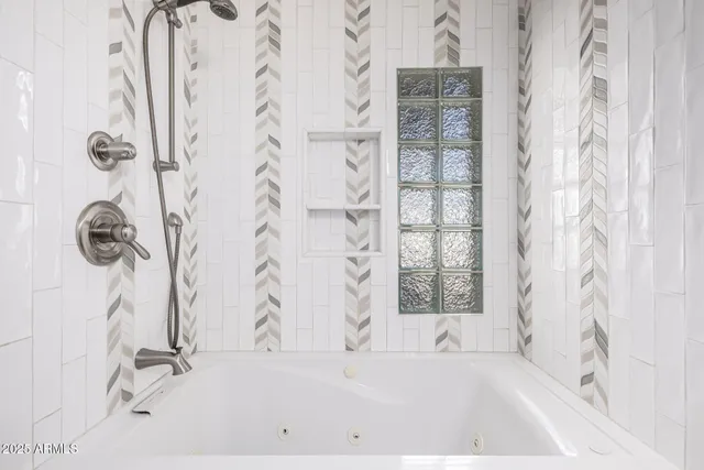 a bathroom with a bathtub and shower