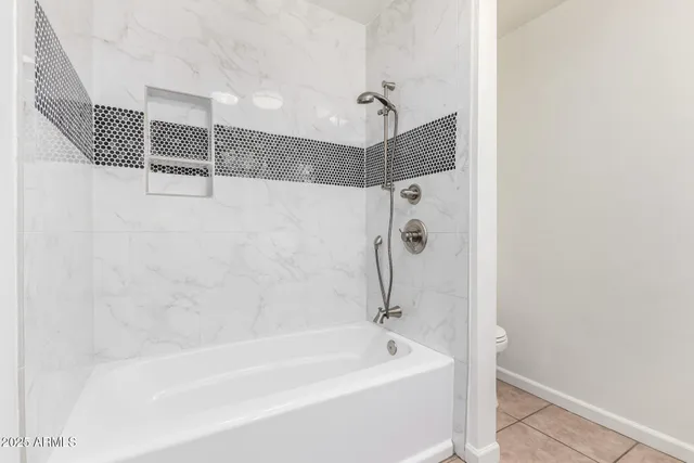 a bathroom with a bathtub and shower