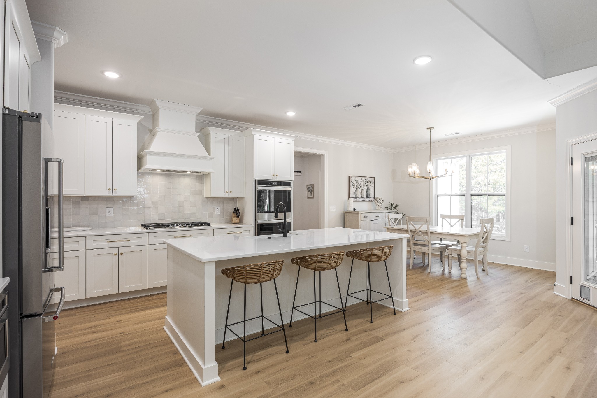 2159 Carpenter Bridge Road Columbia, TN 38401 - Photo 15 of 72 a kitchen with a sink a stove a refrigerator and white cabinets with wooden floor