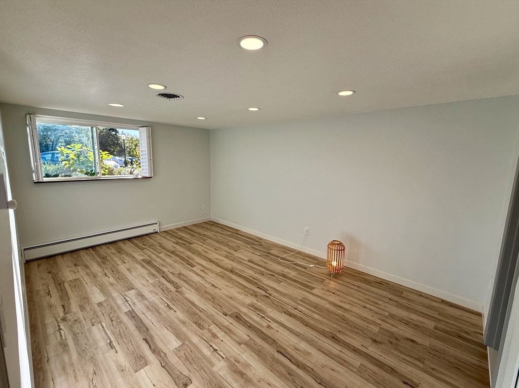 1206 Greendale Avenue, Unit 201 Needham, MA 02492 - Photo 16 of 39 a view of a room with wooden floor and wall