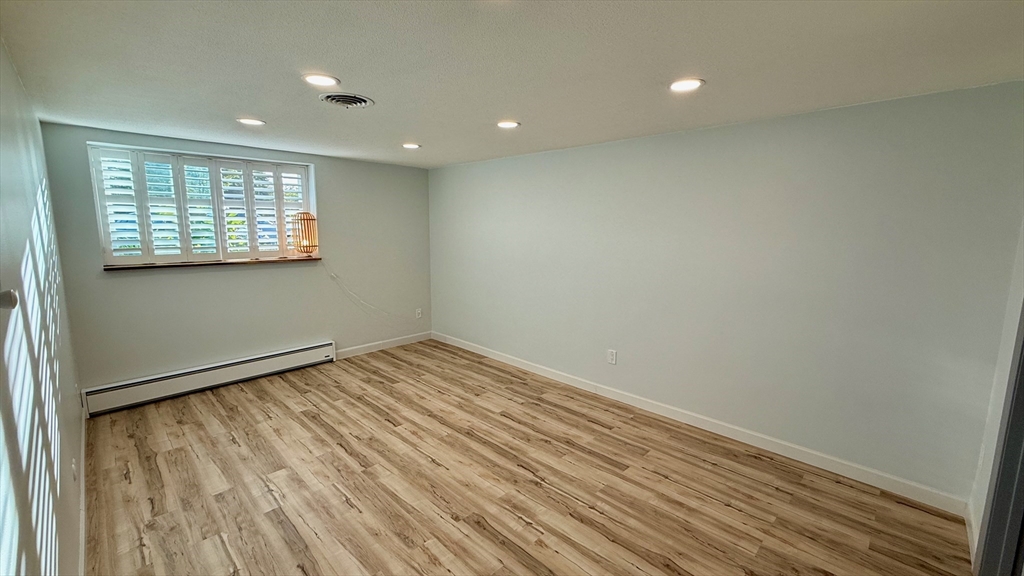 1206 Greendale Avenue, Unit 201 Needham, MA 02492 - Photo 17 of 39 an empty room with wooden floor and windows