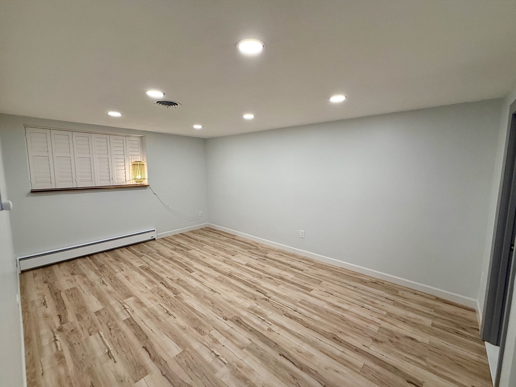 1206 Greendale Avenue, Unit 201 Needham, MA 02492 - Photo 18 of 39 an empty room with wooden floor and windows
