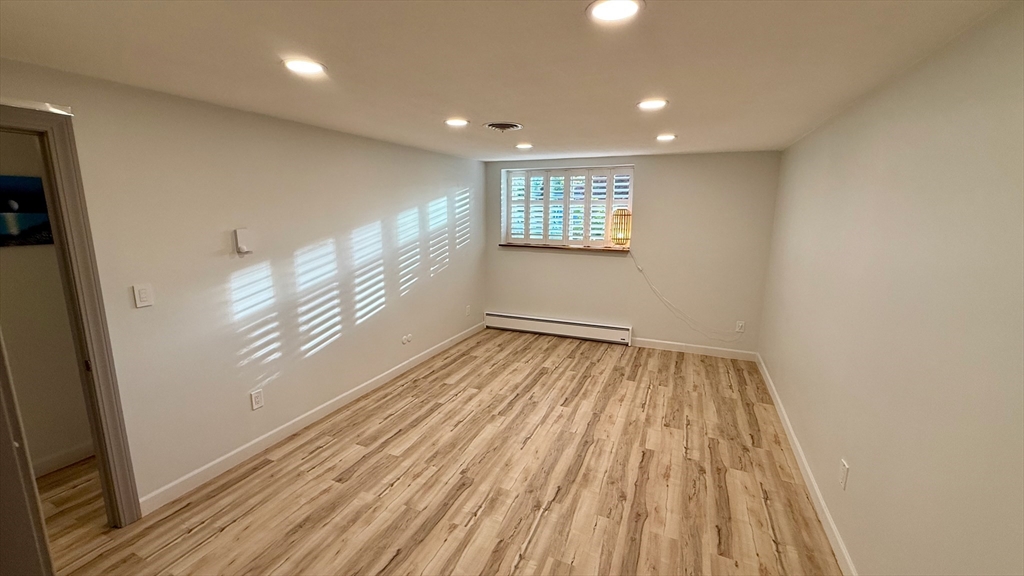 1206 Greendale Avenue, Unit 201 Needham, MA 02492 - Photo 20 of 39 a view of empty room with wooden floor and fan