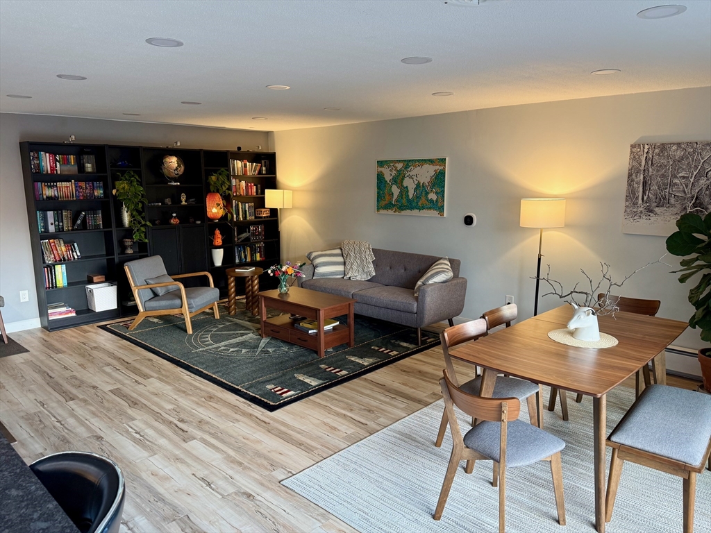 1206 Greendale Avenue, Unit 201 Needham, MA 02492 - Photo 2 of 39 a living room with furniture and a flat screen tv