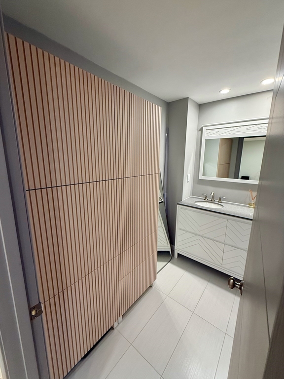 1206 Greendale Avenue, Unit 201 Needham, MA 02492 - Photo 23 of 39 a bathroom with a sink a mirror and bathtub
