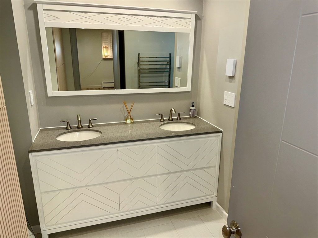 1206 Greendale Avenue, Unit 201 Needham, MA 02492 - Photo 24 of 39 a bathroom with a sink and a mirror