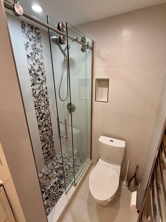 1206 Greendale Avenue, Unit 201 Needham, MA 02492 - Photo 27 of 39 a bathroom with a toilet and a shower