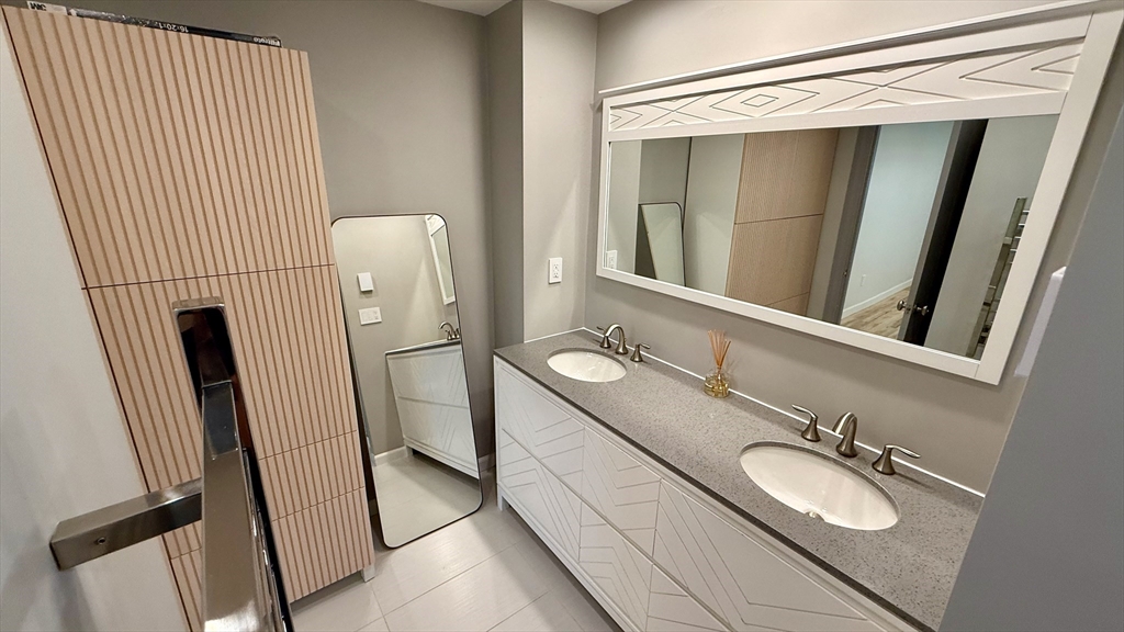 1206 Greendale Avenue, Unit 201 Needham, MA 02492 - Photo 28 of 39 a bathroom with a sink and mirror with toilet