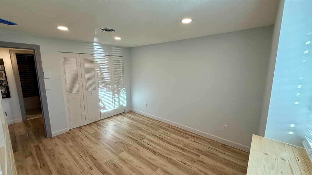 1206 Greendale Avenue, Unit 201 Needham, MA 02492 - Photo 31 of 39 an empty room with wooden floor and entrance