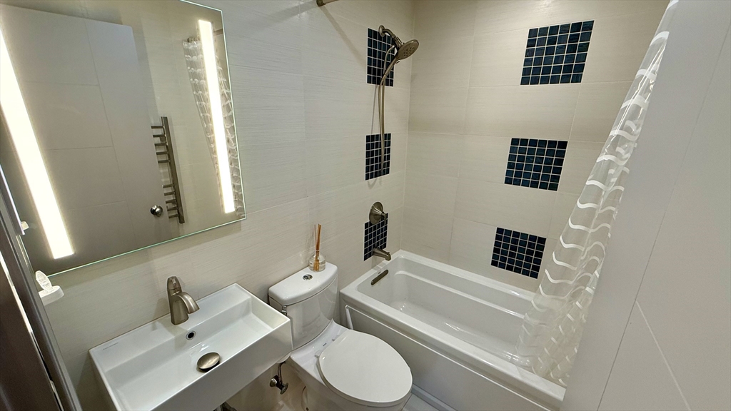 1206 Greendale Avenue, Unit 201 Needham, MA 02492 - Photo 33 of 39 a bathroom with a sink and a mirror