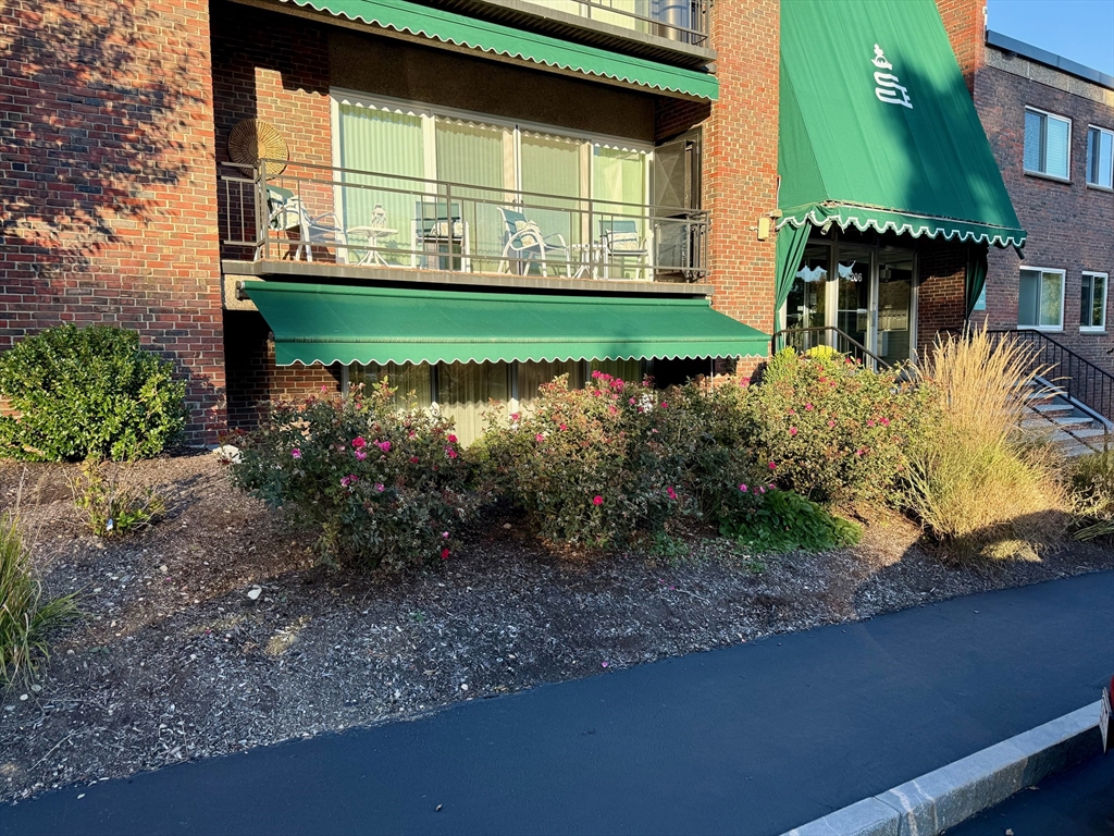 1206 Greendale Avenue, Unit 201 Needham, MA 02492 - Photo 36 of 39 a view of a house with a yard