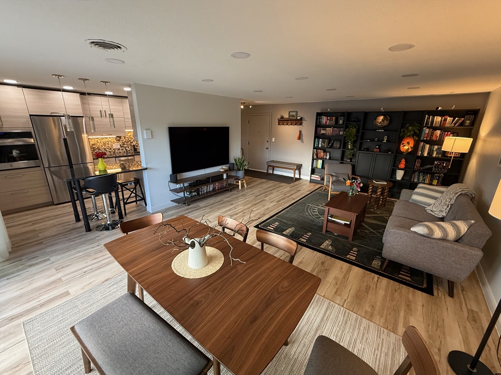 1206 Greendale Avenue, Unit 201 Needham, MA 02492 - Photo 4 of 39 a living room with furniture and a flat screen tv
