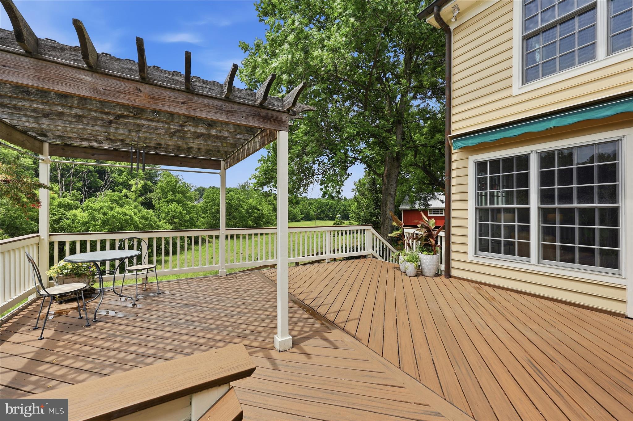 10919 Etzler Mill Road Woodsboro, MD 21798 - Photo 34 of 54 a view of a roof deck with wooden floor and fence with a floor to ceiling window