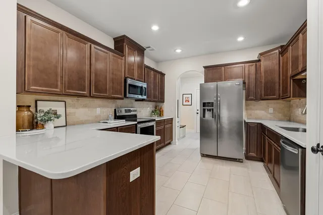 a dining room with furniture a flat screen tv and a chandelier