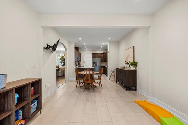a bedroom with a bed couch tv and a window