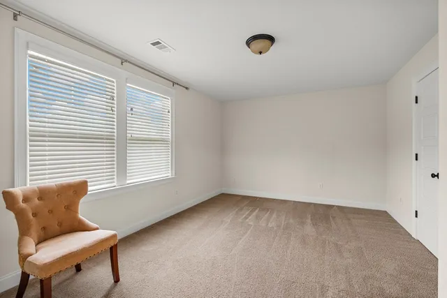 a bathroom with a granite countertop sink a toilet and a mirror
