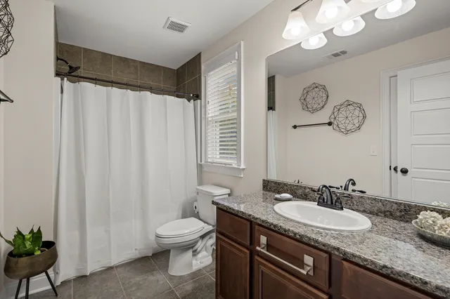 a living room with furniture and gym equipment