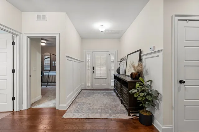 a view of entryway with wooden floor and stairs