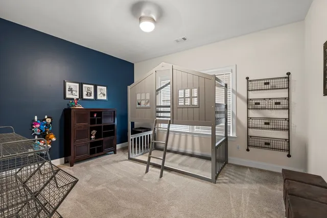 a bedroom with furniture and a flat screen tv