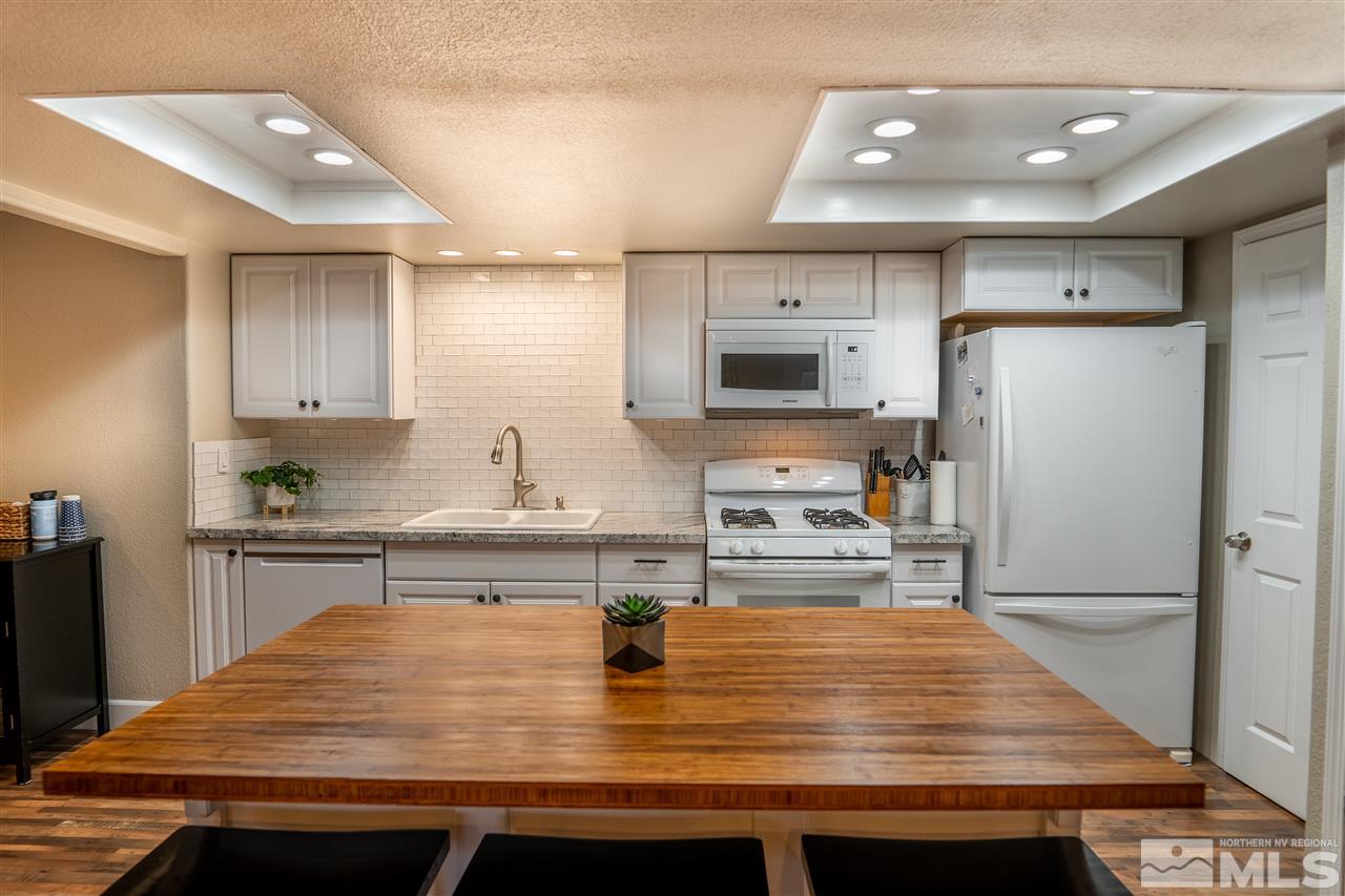 9335 Fremont Way Reno, NV 89506 - Photo 1 of 16 a kitchen with kitchen island a sink stainless steel appliances and counter space