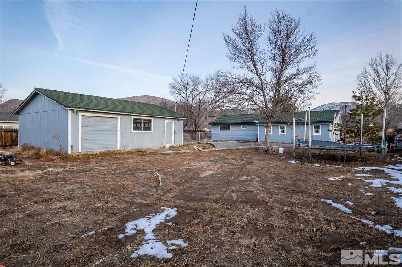 9335 Fremont Way Reno, NV 89506 - Photo 15 of 16 a backyard of a house with large trees and outdoor seating