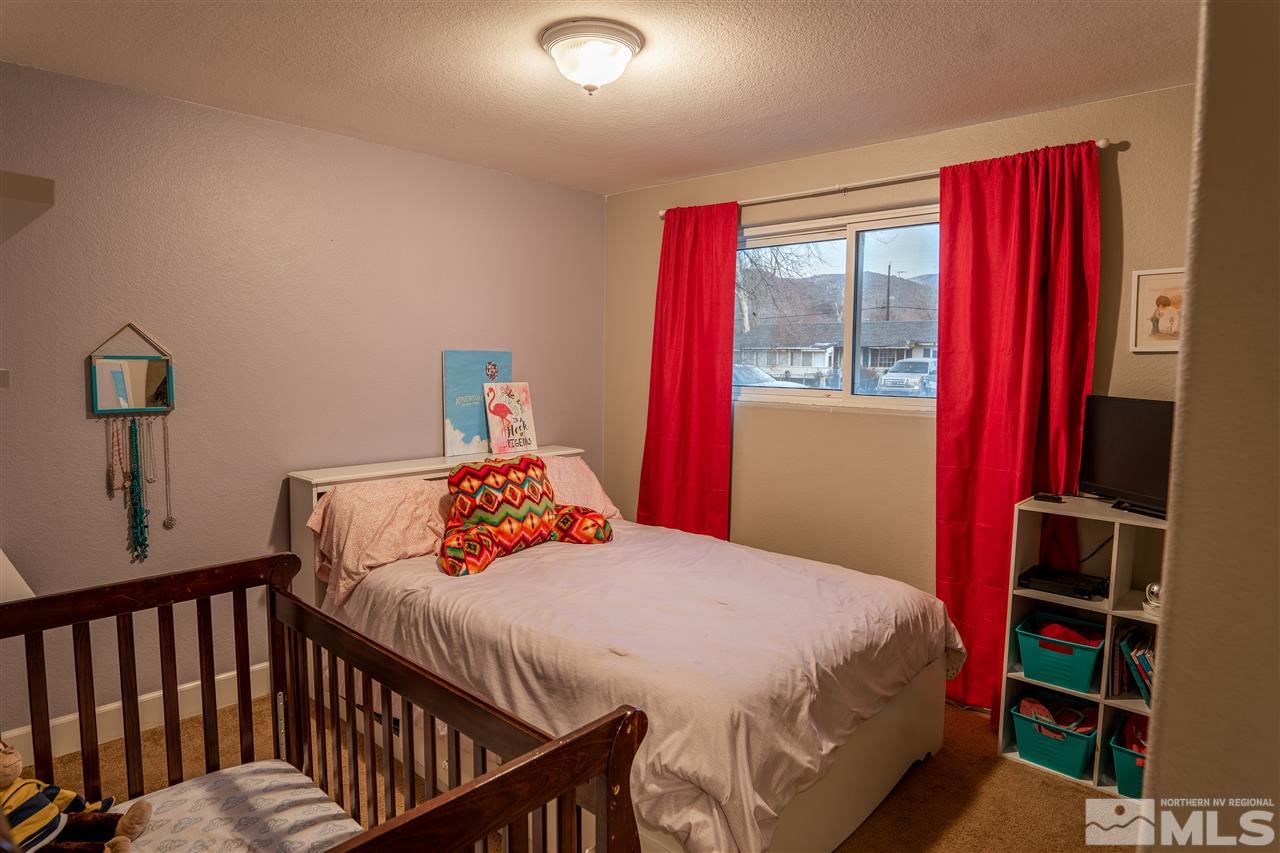 9335 Fremont Way Reno, NV 89506 - Photo 8 of 16 a bedroom with a bed and a window
