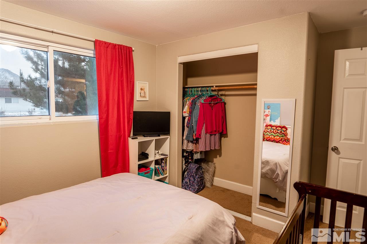 9335 Fremont Way Reno, NV 89506 - Photo 9 of 16 a bed room with a bed and a flat tv screen