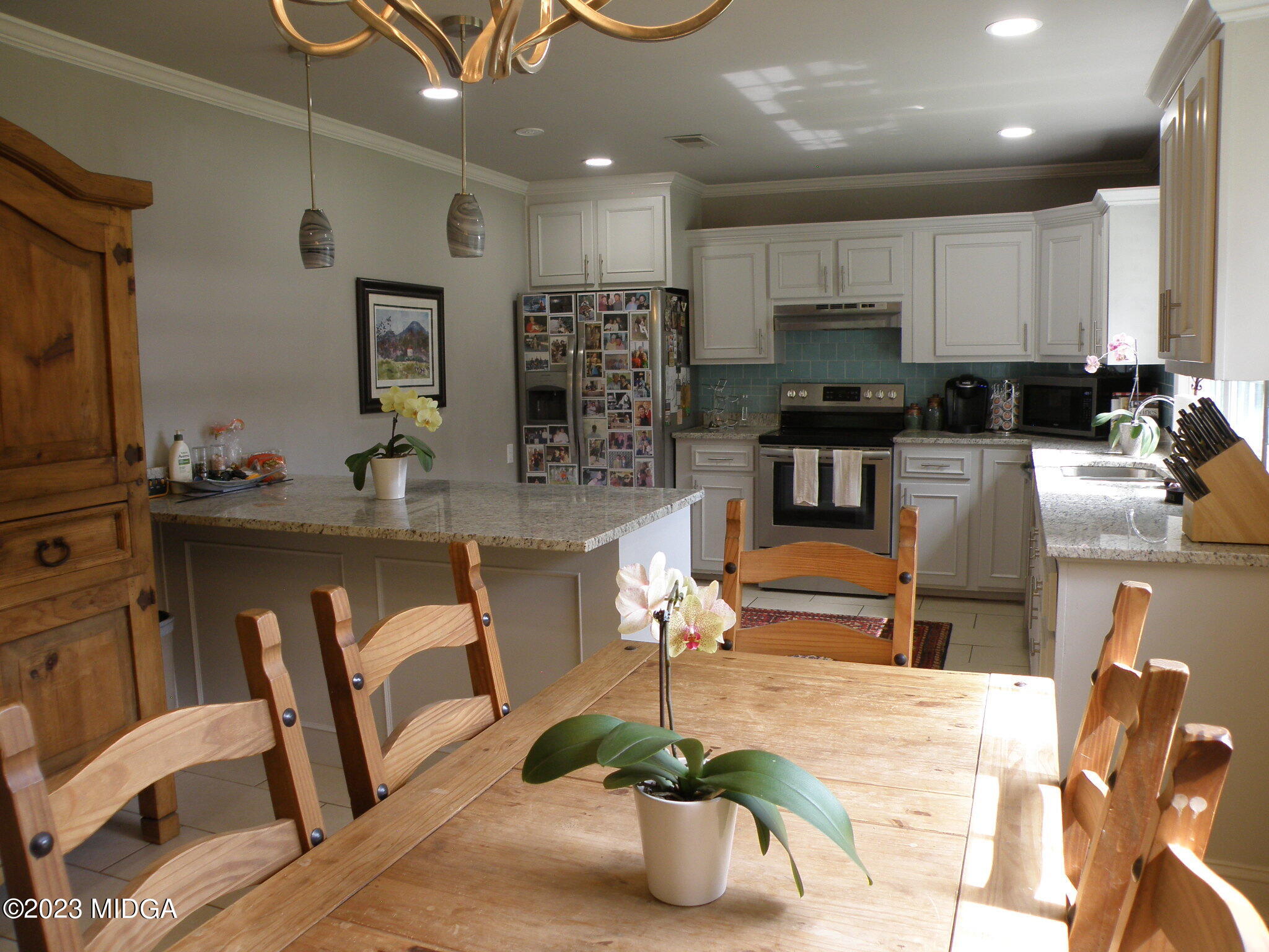 388 Fairview Church Road Forsyth, GA 31029 - Photo 22 of 41 a kitchen with stainless steel appliances granite countertop a refrigerator a stove a sink dishwasher and white cabinets with wooden floor