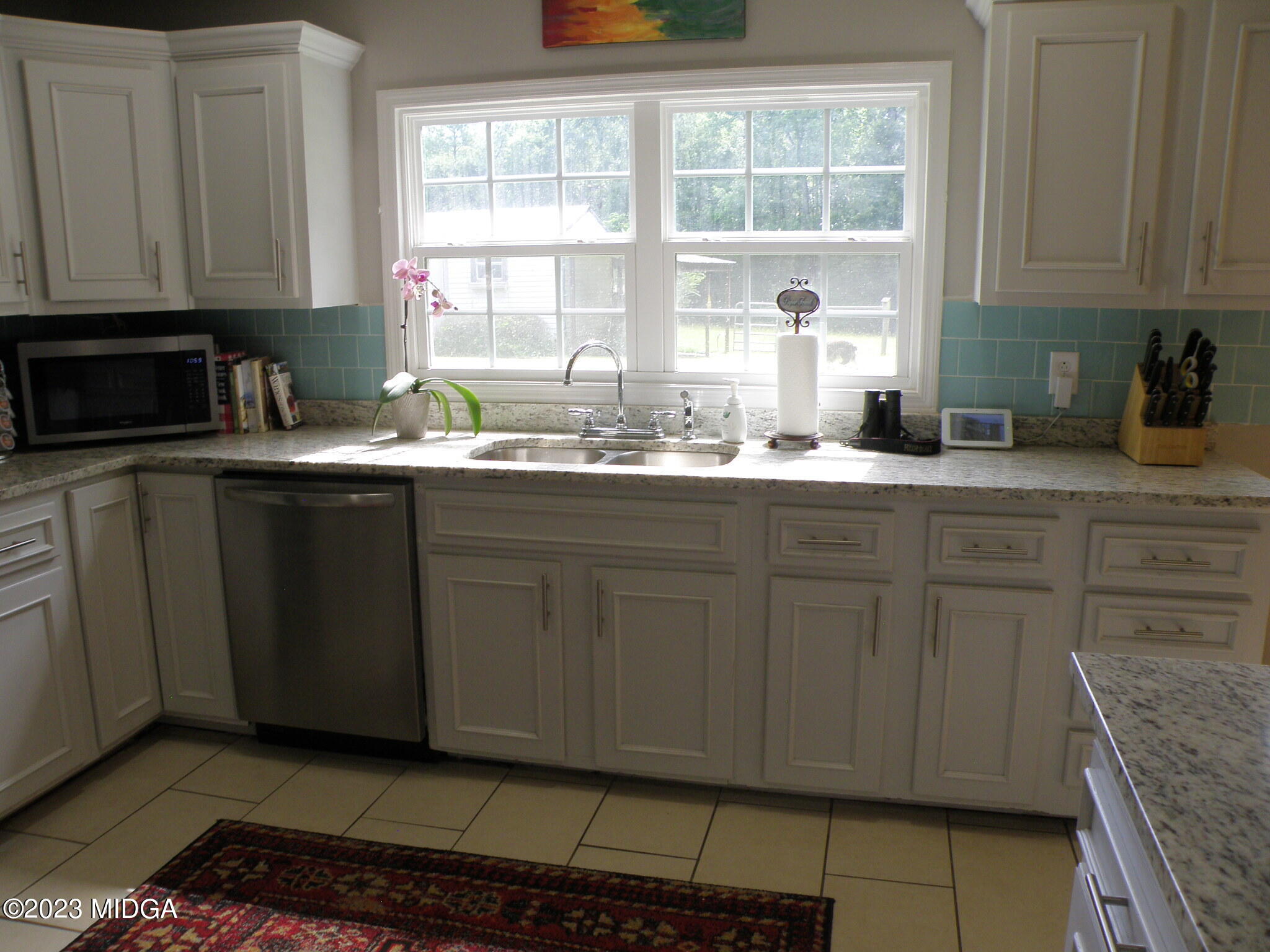 388 Fairview Church Road Forsyth, GA 31029 - Photo 25 of 41 a kitchen with granite countertop cabinets sink and window