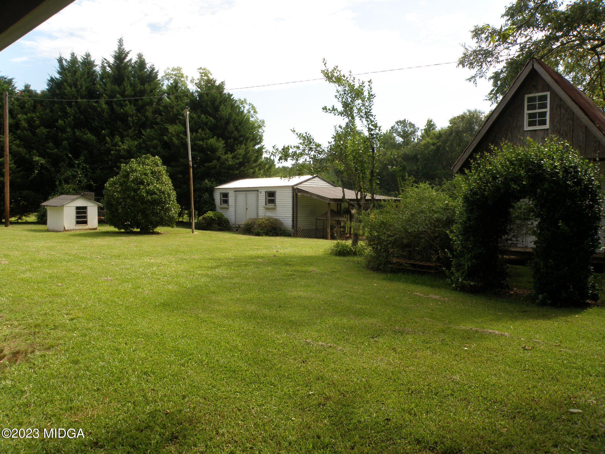 388 Fairview Church Road Forsyth, GA 31029 - Photo 27 of 41 a view of a house with a yard and sitting area