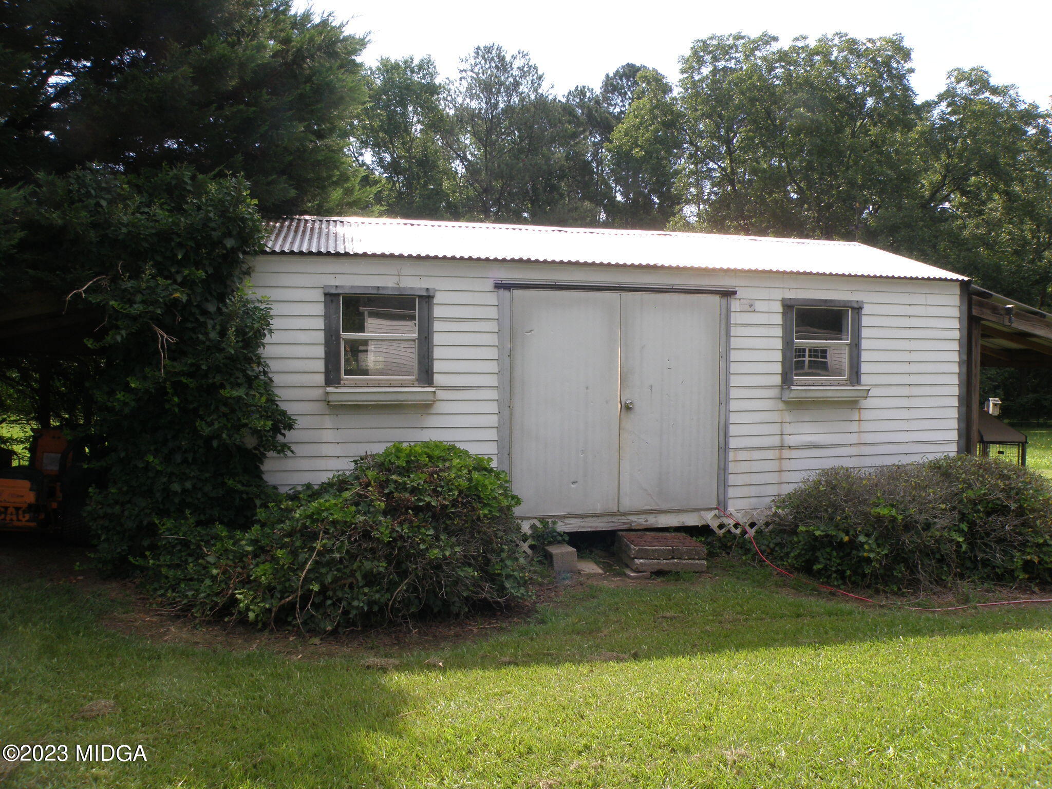 388 Fairview Church Road Forsyth, GA 31029 - Photo 32 of 41 a view of backyard with potted plants and large tree