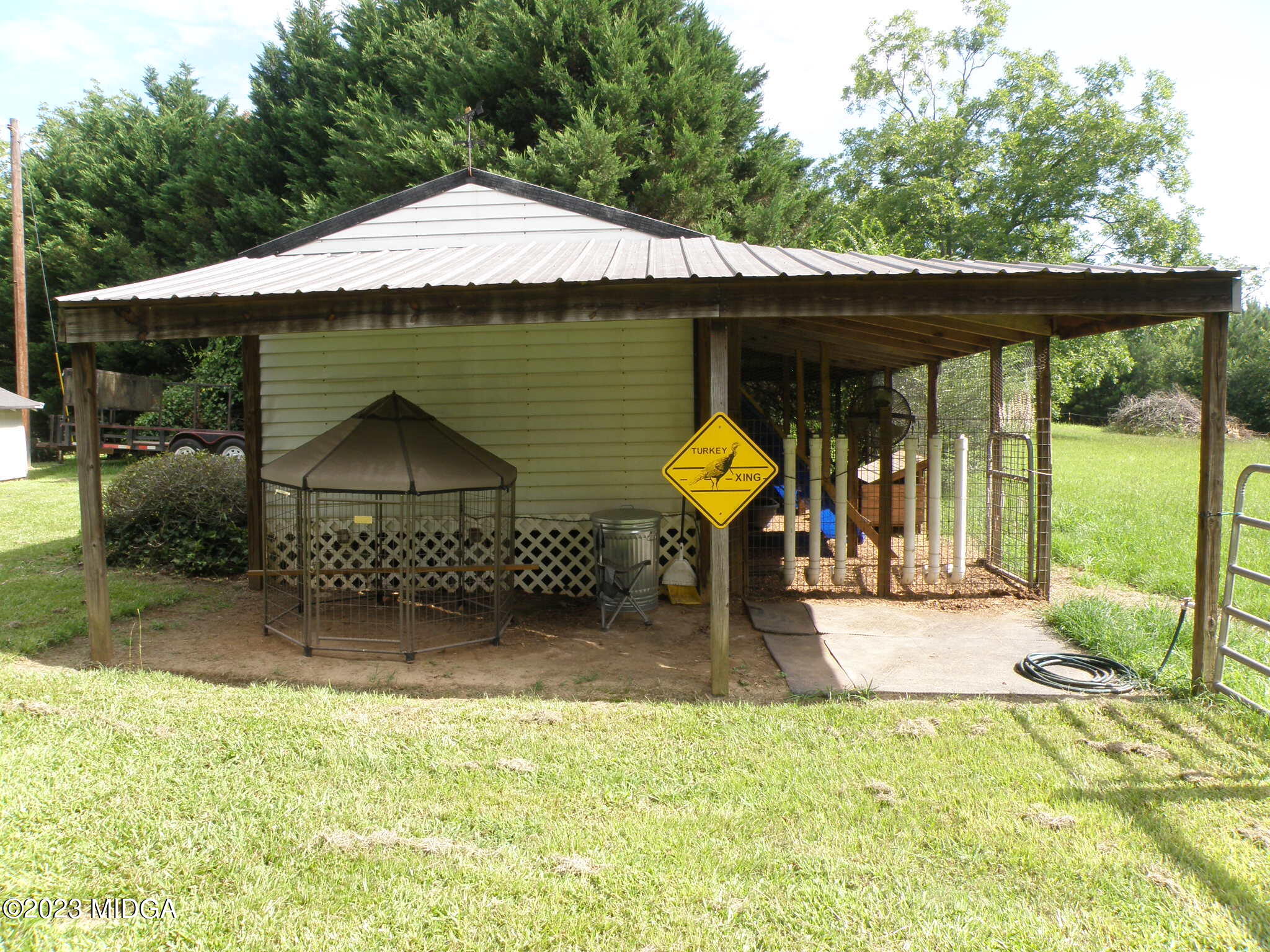 388 Fairview Church Road Forsyth, GA 31029 - Photo 33 of 41 a view of a garden with a table and chairs under an umbrella