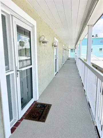 a view of a living room and entryway with wooden floor