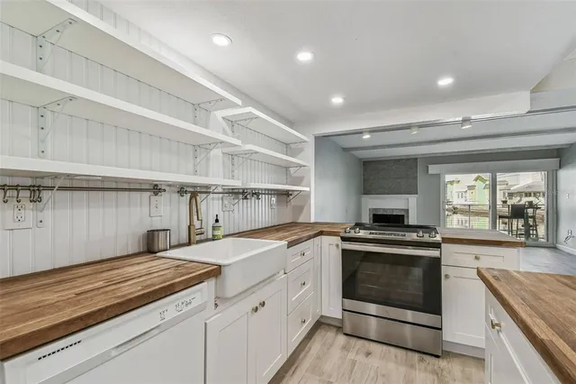a view of a kitchen with kitchen island a sink and wooden floor
